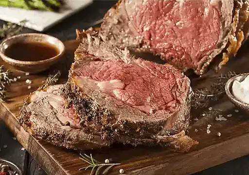 Peppered Rib Eye Roast with roasted garlic sauce